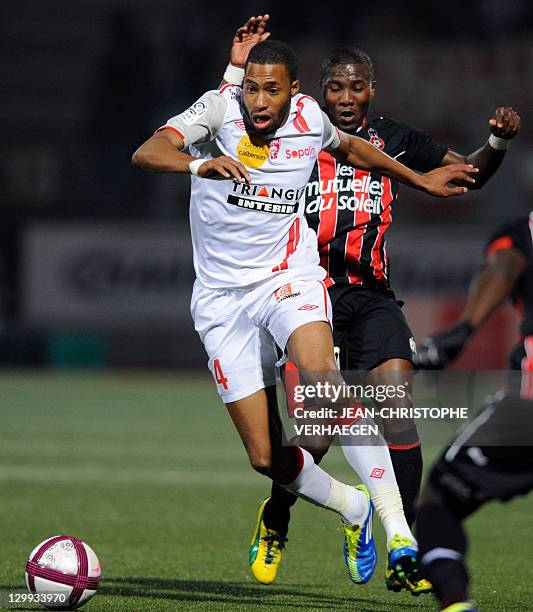 Nancy's French defender Jordan Loties fights for the ball with Nice's Ivorian forward Franck Dja Djedje during their French L1 football match at...