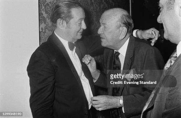 British playwright Sir Terence Rattigan and actor and director Sir Noel Coward at a party, UK, 11th January 1972.