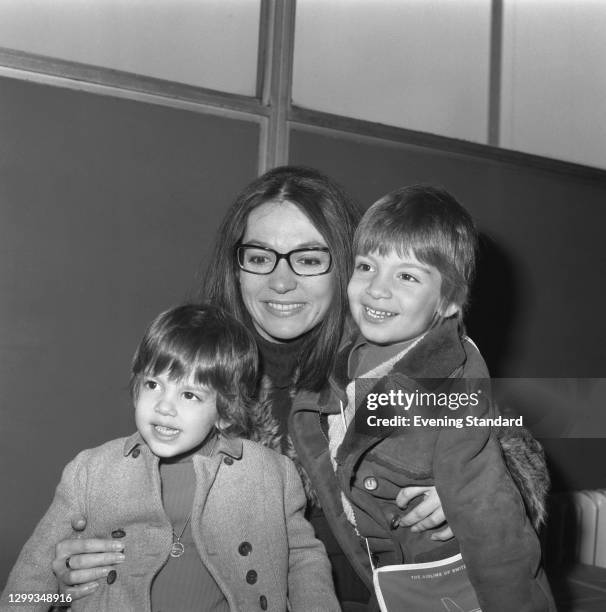 Greek singer Nana Mouskouri with her son Nicolas Petsilas and daughter Hélène Petsilas at Heathrow Airport in London, UK, 2nd November 1972.