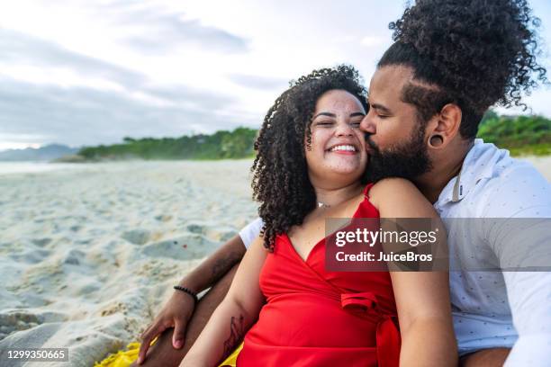 young brazilian couple enjoying a romantic time - young couple red sunny stock pictures, royalty-free photos & images