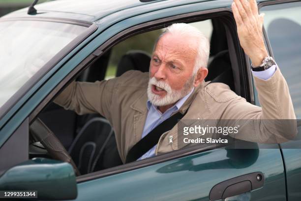 senior man driving car - road rage - grumpy old man stock pictures, royalty-free photos & images