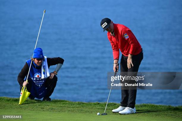 Mackenzie Hughes lines up his putt on the 4th hole green during round two of the Farmers Insurance Open at Torrey Pines on January 29, 2021 in San...