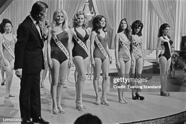 British television host Eric Morley meets some of the contestants in the Miss World 1972 beauty pageant in London, UK, 28th November 1972. From left...