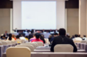 Blurry of auditorium for shareholders' meeting or seminar event with projector,