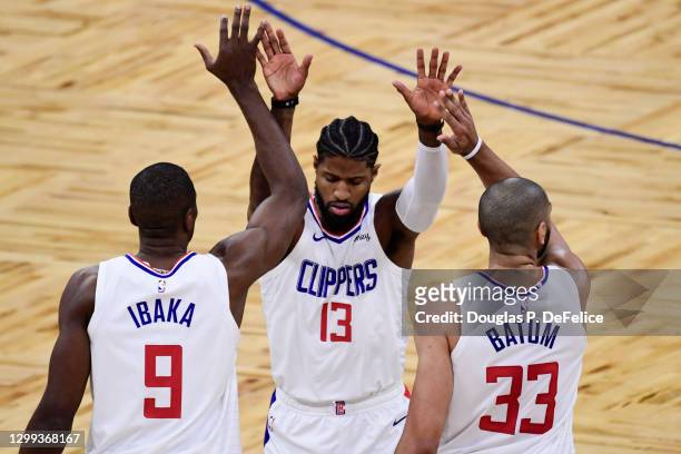 Paul George of the LA Clippers celebrates with teammates Serge Ibaka and Nicolas Batum during the first quarter against the Orlando Magic at Amway...