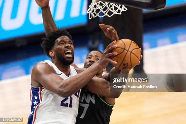 Joel Embiid of the Philadelphia 76ers shoots the ball against Ed Davis of the Minnesota Timberwolves during the second quarter of the game at Target...