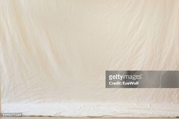 an studio backdrop setup with a natural looking drop cloth with no people - beige stock-fotos und bilder