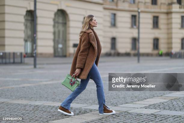Mandy Bork wearing beige Max Mara coat, Hermes sneaker and bag, H&M sweater, Zara pants and Louis Vuitton earring on January 29, 2021 in Berlin,...