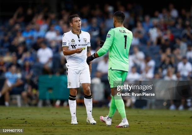 Mark Milligan of Macarthur FC gives the captains armband to Adam Federici of Macarthur FC after being handed a red card for his tackle on Trent...