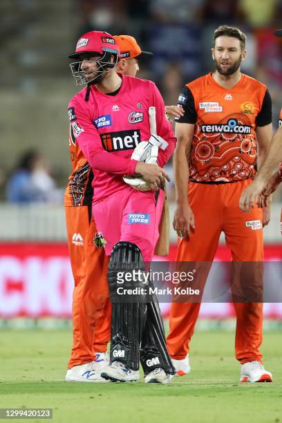 James Vince of the Sixers shows his frustration as he walks away from Andrew Tye of the Scorchers after Tye bowled wide that gave the Sixers the win...