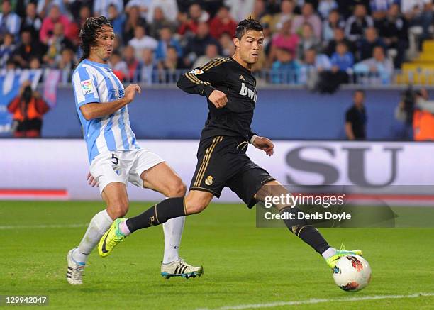 Cristiano Ronaldo of Real Madrid scores his first goal and the second for his team during the La Liga match between Malaga CF and Real Madrid CF at...