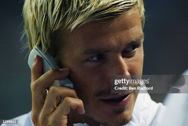 David Beckham of Manchester United makes a phone call during the Pre-Season Amsterdam Tournament match between Manchester United and Parma played at...