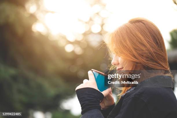 young woman drinking coffee in nature - mug mockup stock pictures, royalty-free photos & images