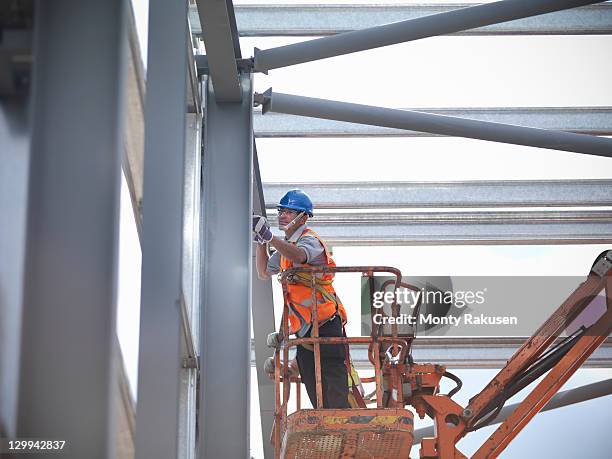 construction workers in cherry picker - cherry picker stock pictures, royalty-free photos & images