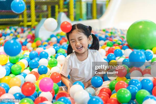 cute girl at the ball pool - ball pit stock pictures, royalty-free photos & images