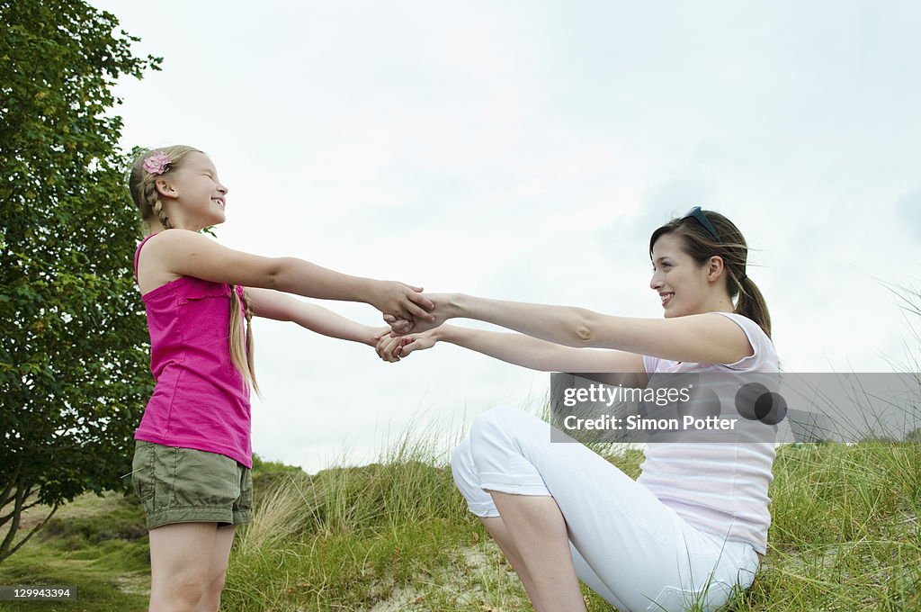 Mother and daughter playing on beach