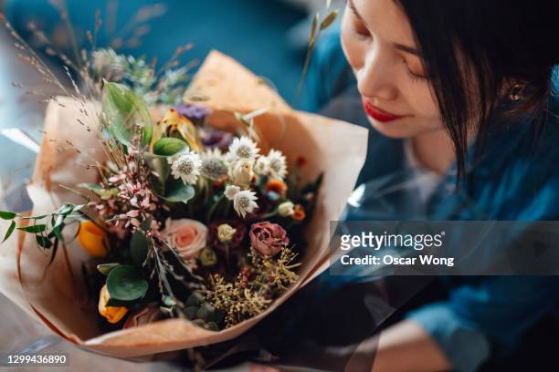 direct above view of young woman receiving flower bouquet - bouquet photos et images de collection