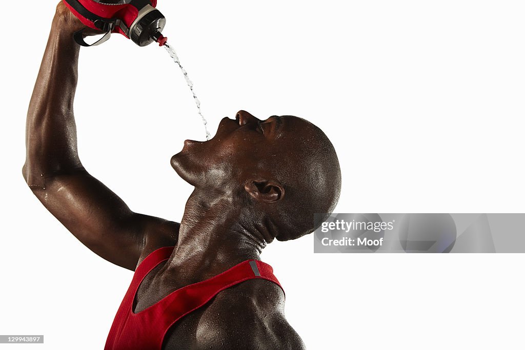 Athlete pouring water into his mouth