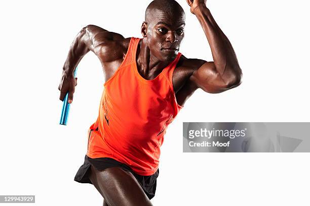 athlete running with relay baton - 1 staffel stock-fotos und bilder
