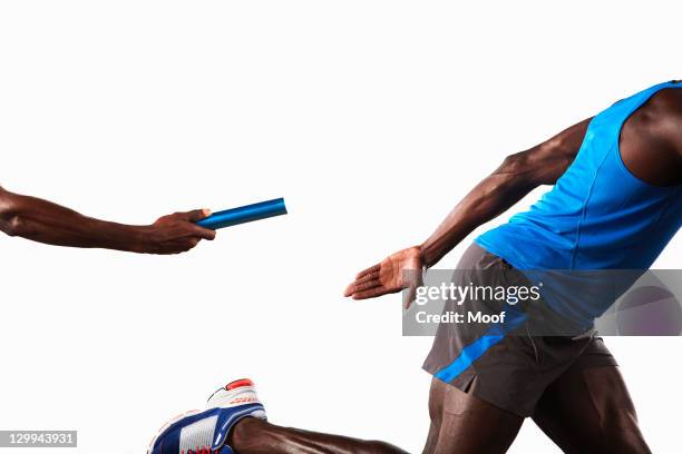 athlete passing relay baton - stafett bildbanksfoton och bilder