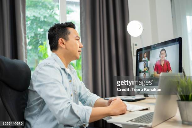 speaker businessman talking at webcam making conference video call and using laptop to work at home - remote location stock pictures, royalty-free photos & images