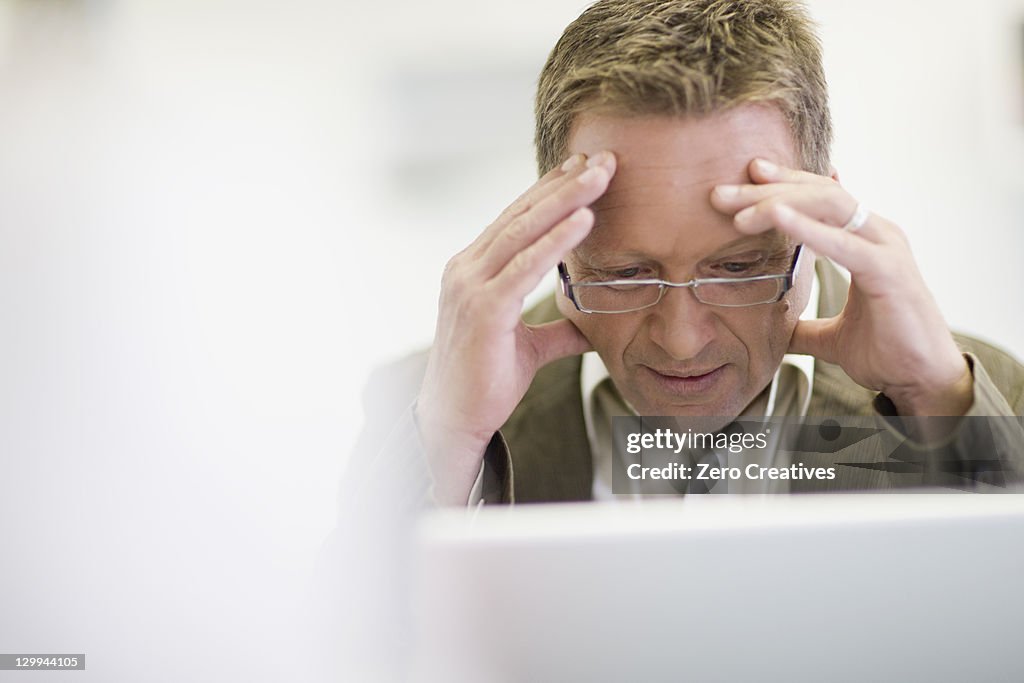 Stressed businessman working in office