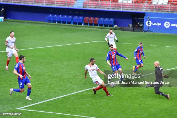 Joan Jordan of Sevilla FC scores their team's second goal past Marko Dmitrovic of Eibar during the La Liga Santander match between SD Eibar and...