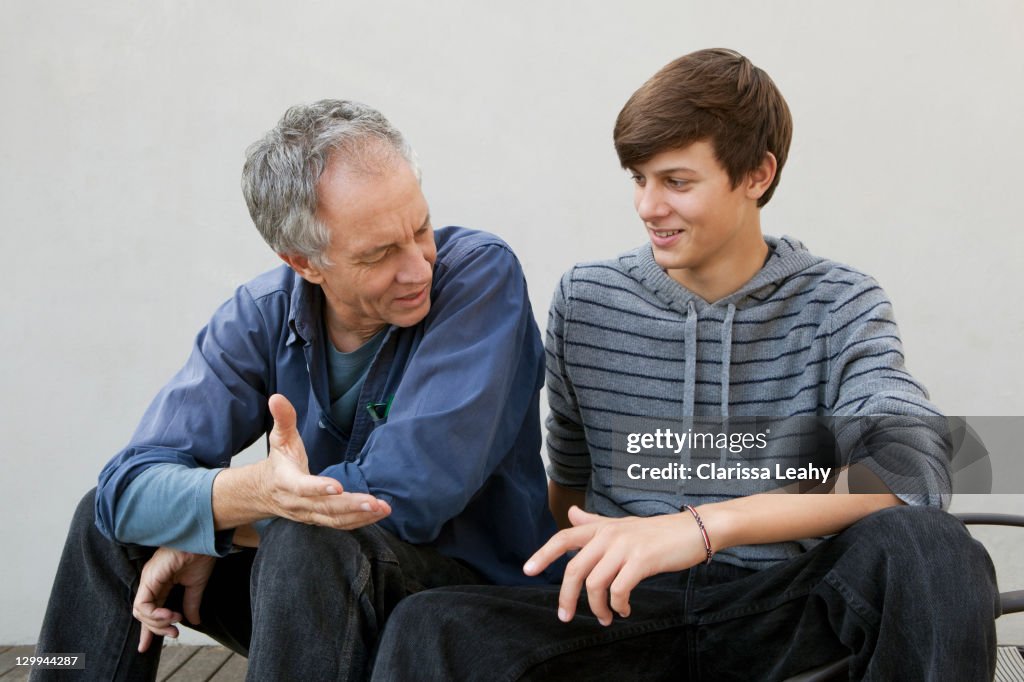 Father and son sitting together