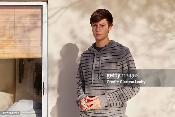 teenage boy standing outdoors - 17 stockfoto's en -beelden