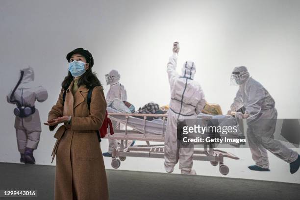 Woman wears a face mask as she visits an exhibition on the city's fight against the coronavirus in Wuhan on January 30, 2021 in Wuhan, China. The WHO...