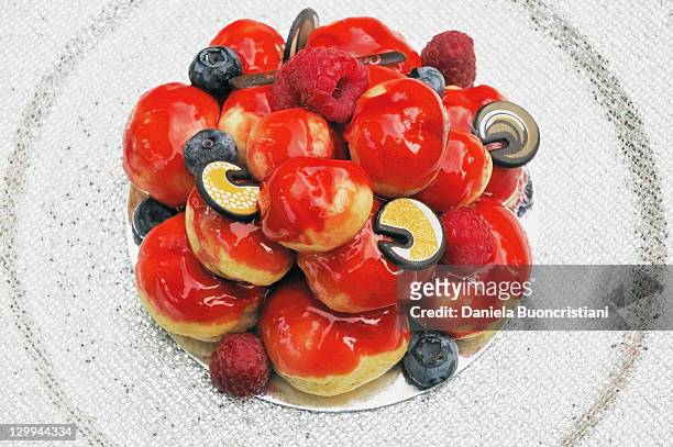 close up of fruit profiterole cake - profiterole stock pictures, royalty-free photos & images