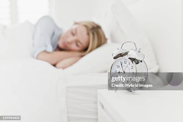 close up of alarm clock on bedside table - alarm clock on nightstand stock pictures, royalty-free photos & images