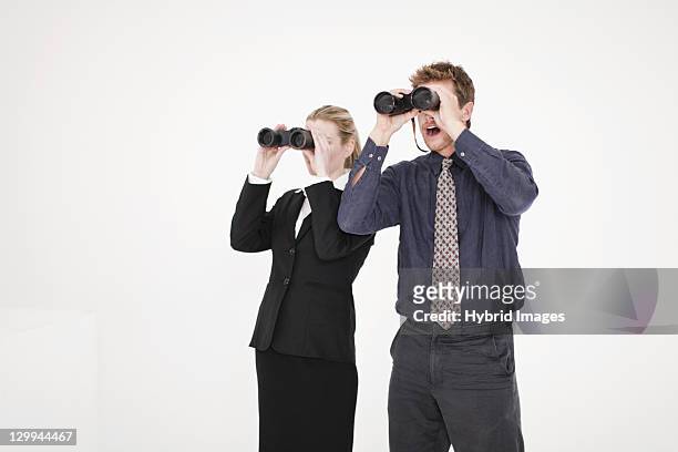 businesspeople using binoculars - spy glass businessman stock pictures, royalty-free photos & images