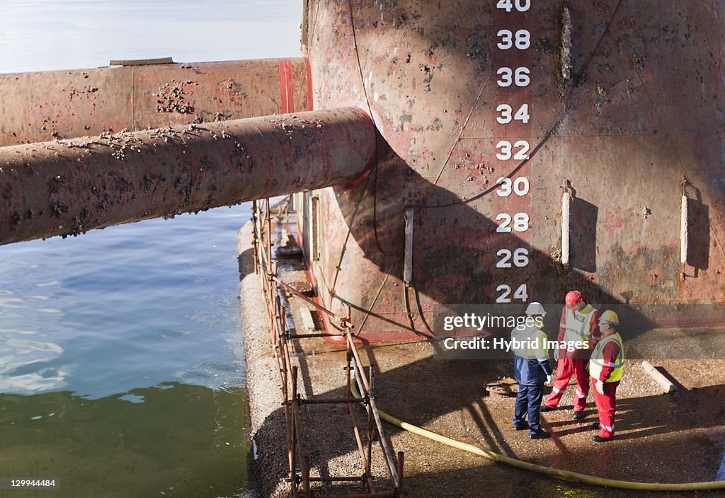 Workers standing on oil rig