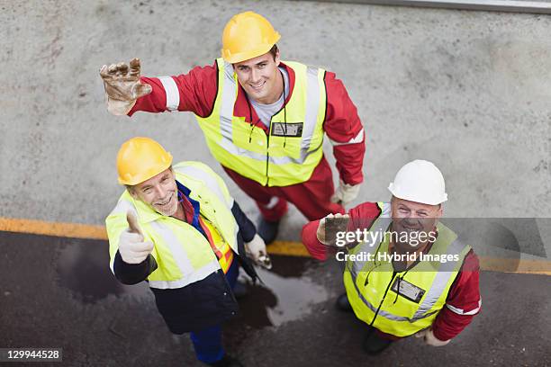workers waving on oil rig - oliewerker stockfoto's en -beelden