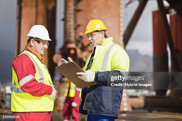 workers talking on oil rig - oil rig worker bildbanksfoton och bilder