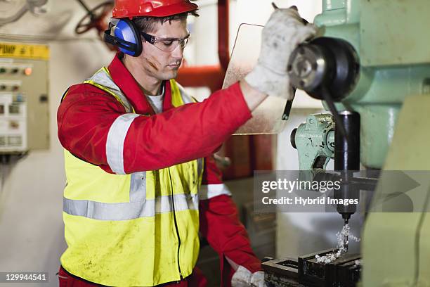worker using machinery on oil rig - operating machinery stock pictures, royalty-free photos & images