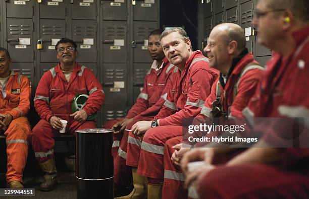 workers sitting in locker room - docker stock pictures, royalty-free photos & images