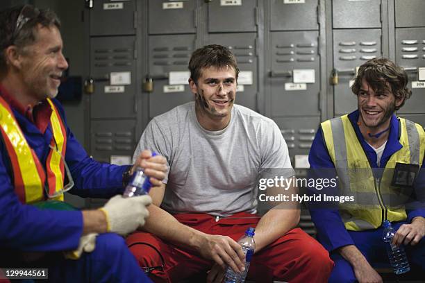 workers sitting in locker room - oil worker stock pictures, royalty-free photos & images
