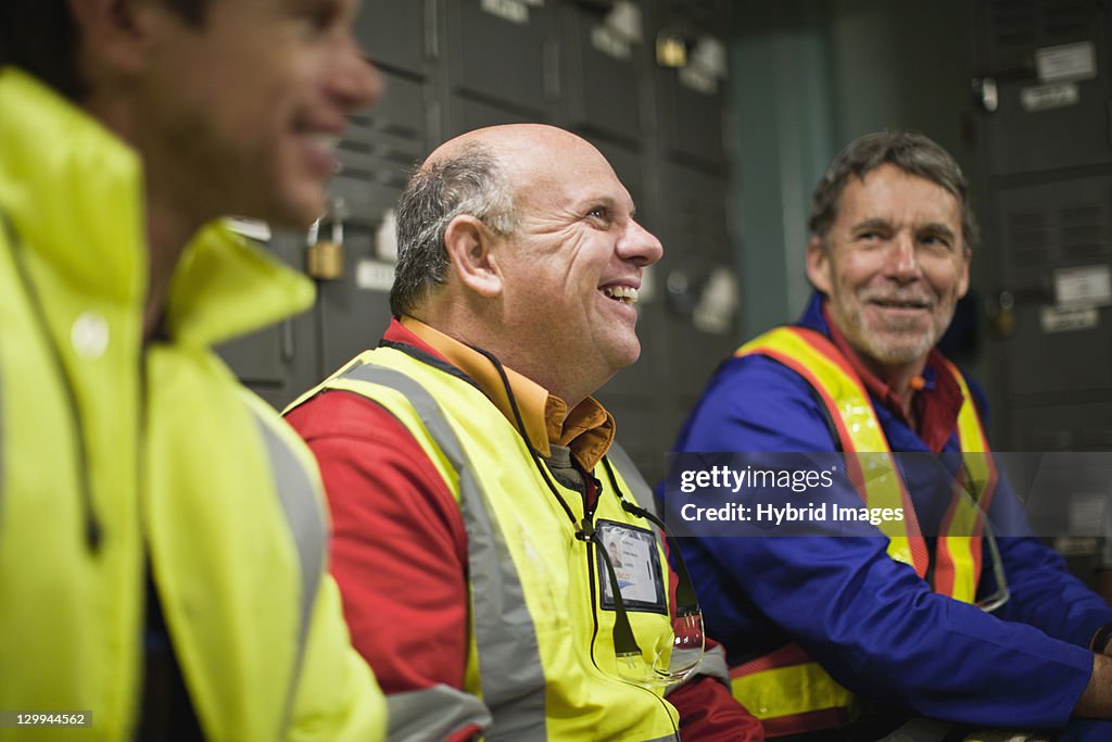 Workers sitting in locker room