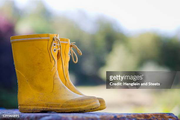 close up of child's rainboots - yellow shoe stock pictures, royalty-free photos & images