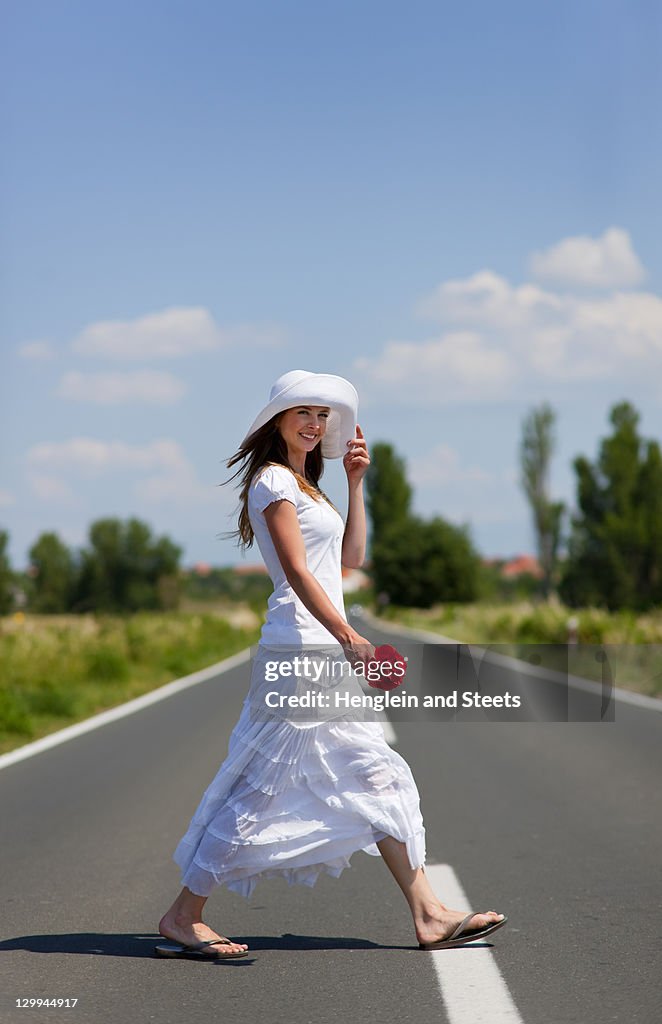 Woman crossing rural road