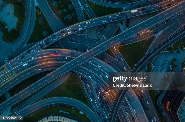 aerial view of overpass and city traffic at rush hour - traffic jam aerial stock pictures, royalty-free photos & images