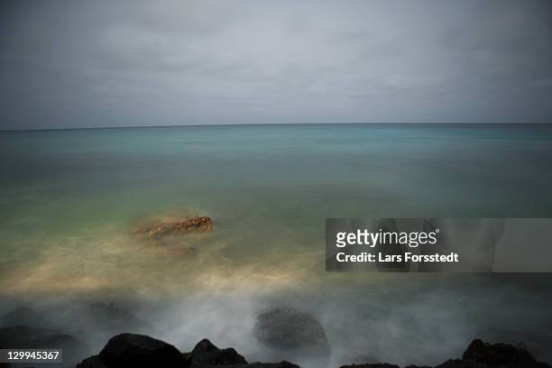 waves and fog over rocks on beach - cape verde night stock pictures, royalty-free photos & images