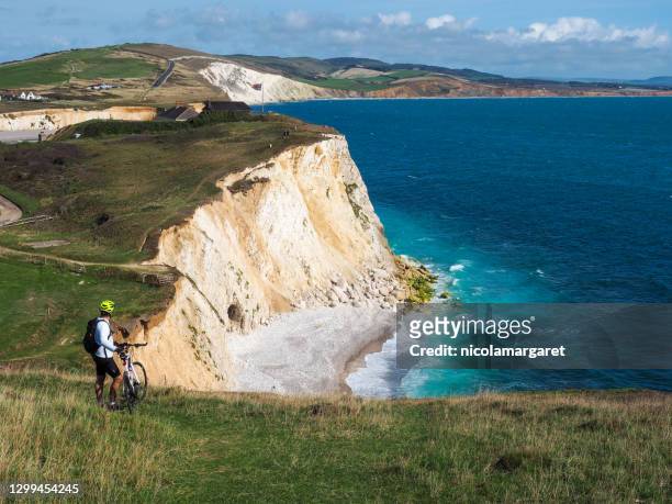 cyclist on clifftop, isle of wight - isle of wight stock pictures, royalty-free photos & images