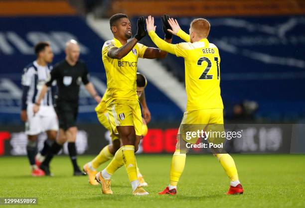 Ivan Cavaleiro of Fulham celebrates with teammate Harrison Reed after scoring their side's second goal during the Premier League match between West...