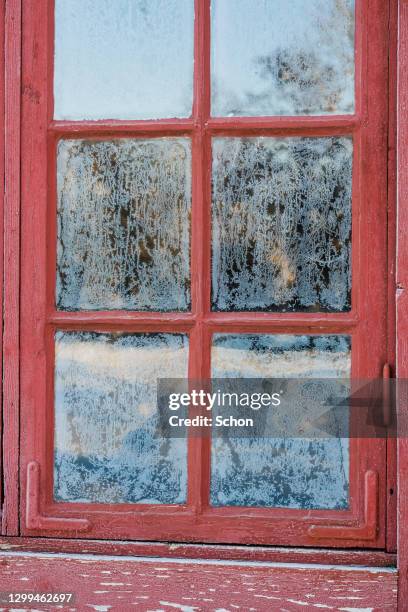 a red window with frost in winter - january background stock pictures, royalty-free photos & images