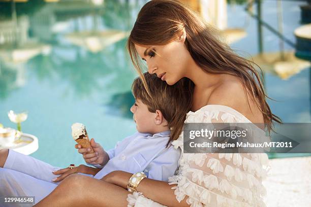 Barron Trump and Melania Trump pose during a photo shoot at the Mar-a-Lago Club on March 26, 2011 in Palm Beach, Florida. Melania's clothes by...