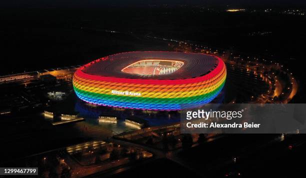 Picture, made with a drone, shows the Allianz Arena soccer stadium illuminated in rainbow colours during the Bundesliga match between FC Bayern...