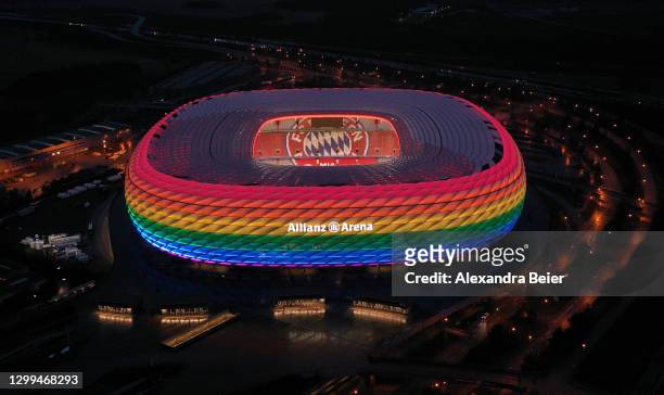 Drone image shows the Allianz Arena soccer stadium illuminated in rainbow colours during the Bundesliga match between FC Bayern Muenchen and TSG...